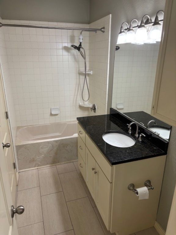 307 Quarry St, San Marcos, TX 78666 - bathroom with vanity, shower / bathtub combination, and tile patterned flooring