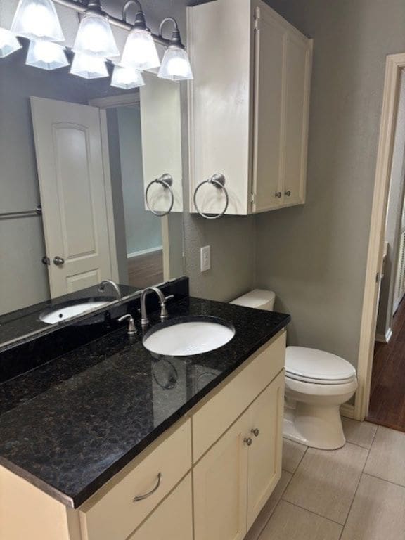 307 Quarry St, San Marcos, TX 78666 - half bathroom with vanity and tile patterned floors