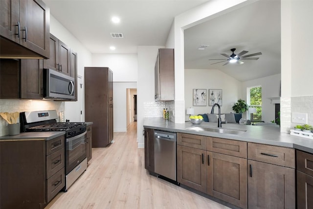 2012 Mimosa Trl, Round Rock, TX 78664 - kitchen featuring stainless steel appliances, a sink, backsplash, a ceiling fan, and light wood-style flooring
