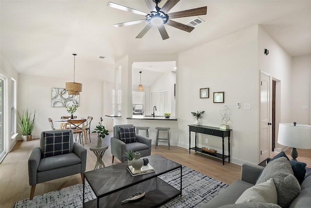 2012 Mimosa Trl, Round Rock, TX 78664 - living area with ceiling fan, wood finished floors, vaulted ceiling, and baseboards