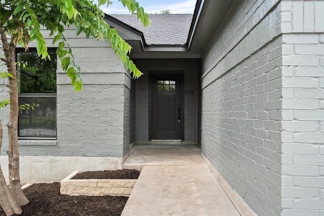 2012 Mimosa Trl, Round Rock, TX 78664 - property entrance featuring roof with shingles and brick siding