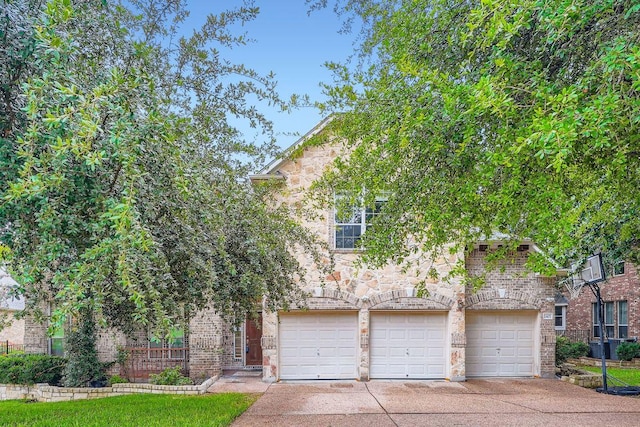 2607 Deep River Cir, Round Rock, TX 78665 - view of property hidden behind natural elements with driveway, an attached garage, and stone siding