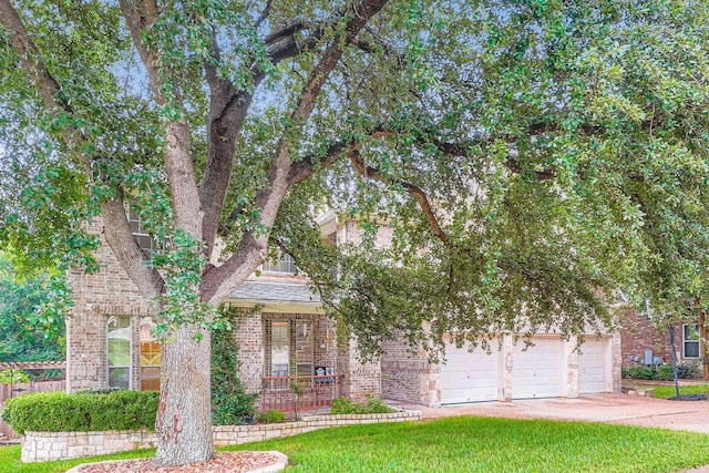 2607 Deep River Cir, Round Rock, TX 78665 - obstructed view of property with brick siding, a garage, and a front yard