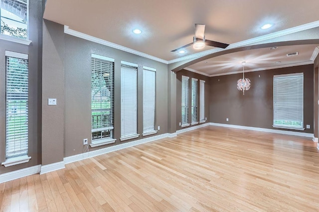 2607 Deep River Cir, Round Rock, TX 78665 - unfurnished room featuring light wood-style flooring, arched walkways, ornamental molding, a ceiling fan, and a textured wall