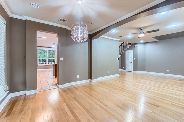 2607 Deep River Cir, Round Rock, TX 78665 - spare room with light wood-style floors, ceiling fan, arched walkways, crown molding, and a chandelier