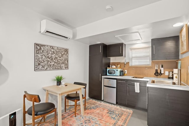 1406 Summit St, Austin, TX 78741 - kitchen with a wall unit AC, freestanding refrigerator, light countertops, backsplash, and a sink