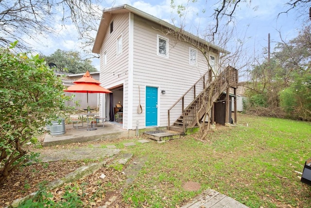 1406 Summit St, Austin, TX 78741 - back of property with stairs, a patio, and a yard