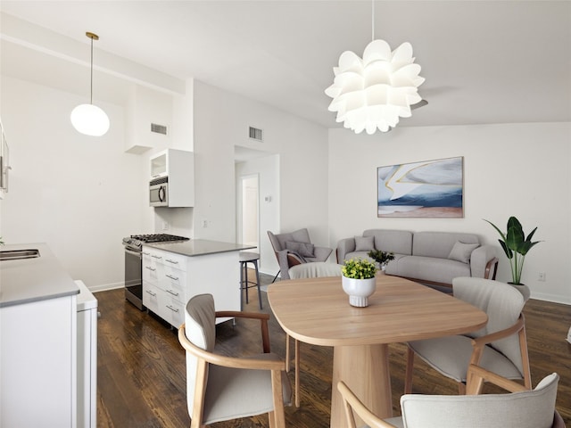 1503 W 9th St Unit 204, Austin, TX 78703 - dining area featuring dark wood-type flooring and baseboards