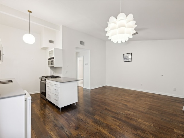 1503 W 9th St Unit 204, Austin, TX 78703 - kitchen featuring stainless steel appliances, dark wood-style flooring, white cabinetry, pendant lighting, and open floor plan