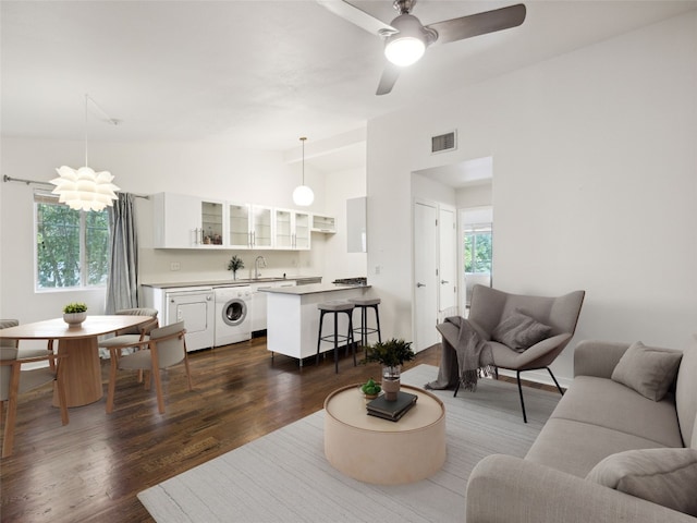 1503 W 9th St Unit 204, Austin, TX 78703 - living area featuring washer / clothes dryer, lofted ceiling, dark wood-type flooring, and ceiling fan