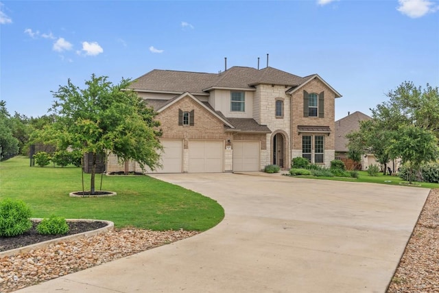 1626 Bearkat Canyon Dr, Dripping Springs, TX 78620 - view of front facade with concrete driveway, a front lawn, roof with shingles, a garage, and brick siding