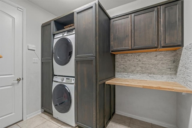 1626 Bearkat Canyon Dr, Dripping Springs, TX 78620 - laundry room featuring stacked washer / dryer, cabinet space, and light tile patterned flooring