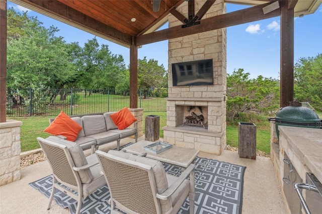 1626 Bearkat Canyon Dr, Dripping Springs, TX 78620 - view of patio / terrace featuring view of wooded area and an outdoor living space with a fireplace