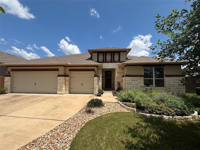 707 Mendocino Ln, Austin, TX 78737 - prairie-style home with stone siding, an attached garage, and driveway