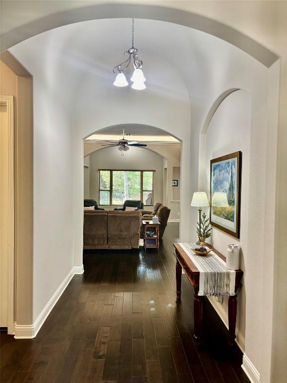 707 Mendocino Ln, Austin, TX 78737 - corridor with arched walkways, dark wood-style floors, and baseboards
