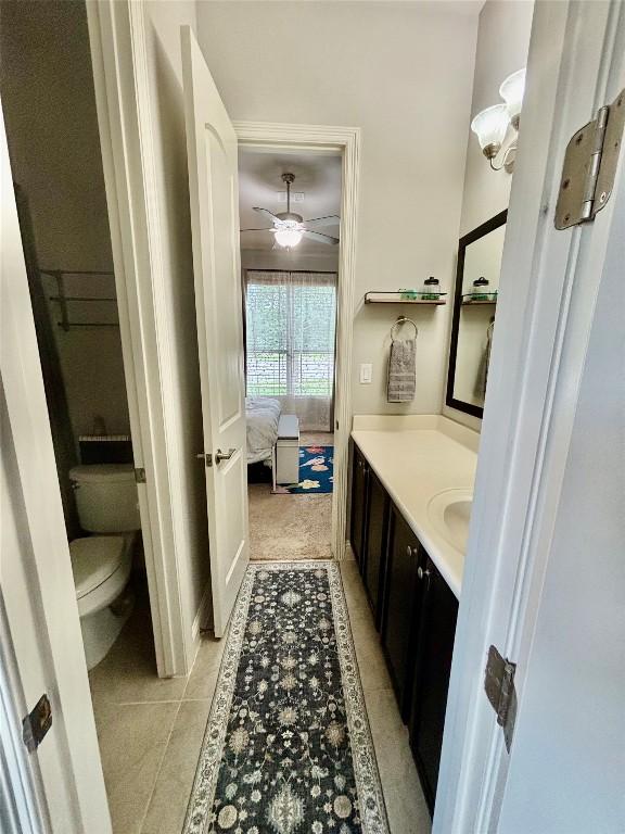 707 Mendocino Ln, Austin, TX 78737 - bathroom featuring vanity, toilet, tile patterned floors, a ceiling fan, and ensuite bathroom