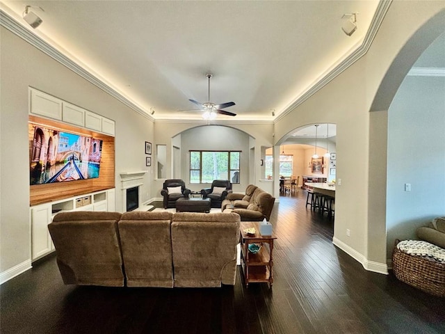 707 Mendocino Ln, Austin, TX 78737 - living room with arched walkways, ornamental molding, ceiling fan, dark wood finished floors, and a fireplace