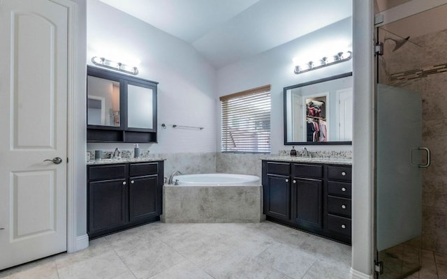 707 Mendocino Ln, Austin, TX 78737 - full bathroom featuring a shower stall, two vanities, a garden tub, tile patterned flooring, and vaulted ceiling