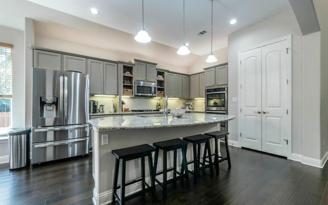 707 Mendocino Ln, Austin, TX 78737 - kitchen with appliances with stainless steel finishes, gray cabinetry, open shelves, dark wood-style floors, and light stone counters