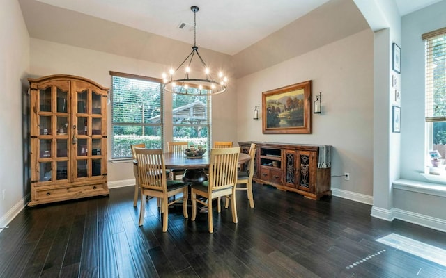 707 Mendocino Ln, Austin, TX 78737 - dining space with arched walkways, wood finished floors, and a chandelier