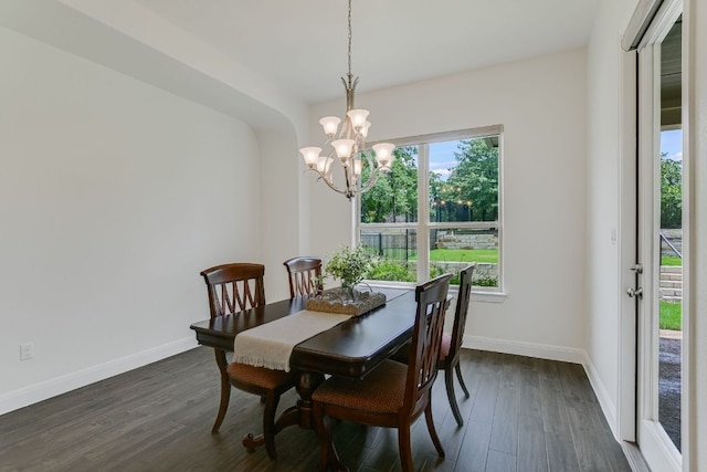 119 Loysoya St, Bastrop, TX 78602 - dining room with a chandelier, dark wood-style flooring, and baseboards