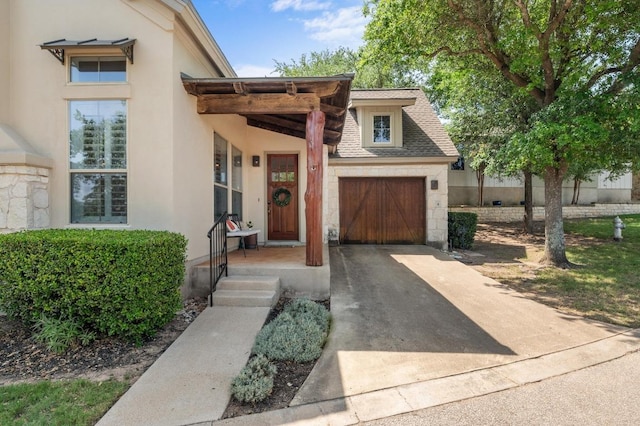 6201 River Place Blvd Unit 4, Austin, TX 78730 - view of front of house featuring concrete driveway, stucco siding, an attached garage, and a shingled roof