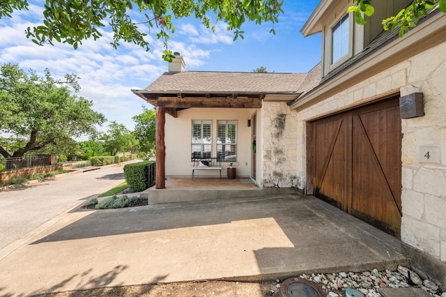 6201 River Place Blvd Unit 4, Austin, TX 78730 - property entrance with stone siding, a garage, and a chimney