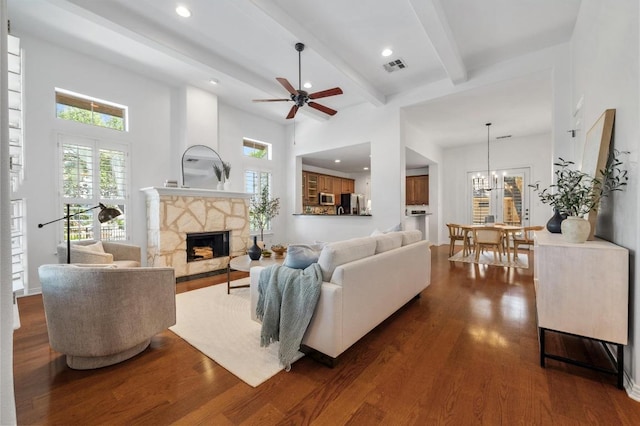 6201 River Place Blvd Unit 4, Austin, TX 78730 - living room with dark wood-style floors, a stone fireplace, recessed lighting, beam ceiling, and a ceiling fan