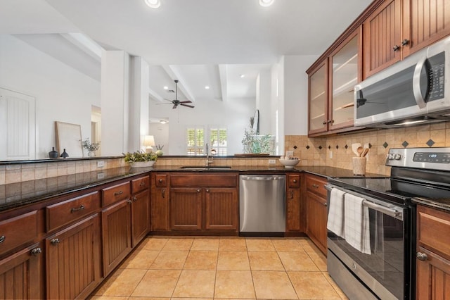 6201 River Place Blvd Unit 4, Austin, TX 78730 - kitchen featuring stainless steel appliances, ceiling fan, decorative backsplash, beamed ceiling, and dark stone countertops