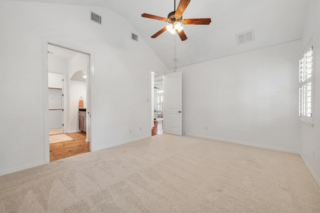 6201 River Place Blvd Unit 4, Austin, TX 78730 - unfurnished bedroom featuring carpet floors, arched walkways, connected bathroom, a ceiling fan, and high vaulted ceiling