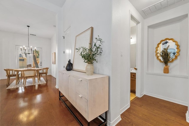 6201 River Place Blvd Unit 4, Austin, TX 78730 - hall featuring dark wood-style floors and a chandelier