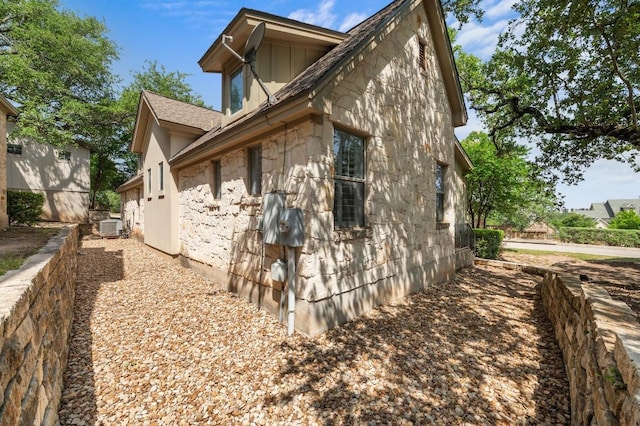 6201 River Place Blvd Unit 4, Austin, TX 78730 - view of property exterior featuring stone siding and a central air condition unit