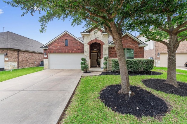 1017 Sussex Way, Round Rock, TX 78665 - traditional home featuring stone siding, a garage, concrete driveway, brick siding, and a front lawn