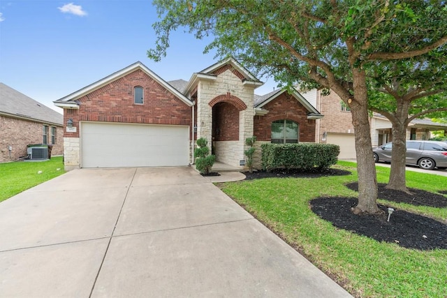 1017 Sussex Way, Round Rock, TX 78665 - traditional-style house with central AC, stone siding, an attached garage, driveway, and a front lawn