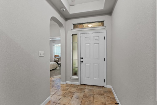 1017 Sussex Way, Round Rock, TX 78665 - entryway with arched walkways, light tile patterned floors, baseboards, and a textured wall