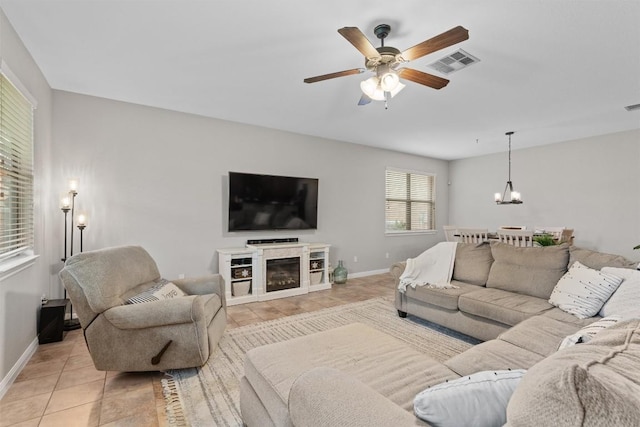 1017 Sussex Way, Round Rock, TX 78665 - living area with a chandelier, a ceiling fan, and baseboards