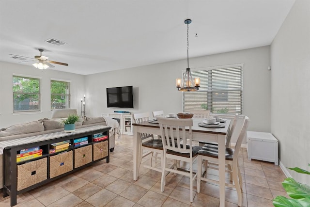 1017 Sussex Way, Round Rock, TX 78665 - dining room featuring light tile patterned floors, a chandelier, and a ceiling fan