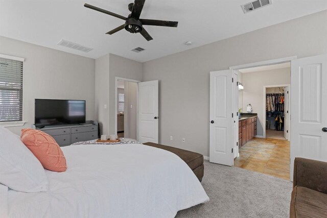 1017 Sussex Way, Round Rock, TX 78665 - bedroom featuring a spacious closet, light carpet, a ceiling fan, and baseboards