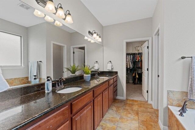 1017 Sussex Way, Round Rock, TX 78665 - full bath with double vanity, a garden tub, and a spacious closet