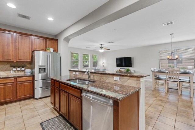 1017 Sussex Way, Round Rock, TX 78665 - kitchen featuring stainless steel appliances, a sink, light tile patterned floors, decorative backsplash, and recessed lighting
