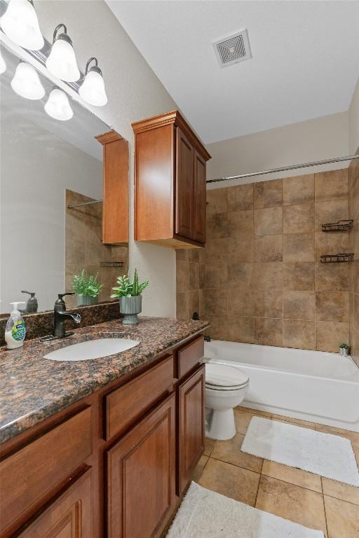 1017 Sussex Way, Round Rock, TX 78665 - full bathroom with vanity, toilet, tile patterned flooring, and bathing tub / shower combination