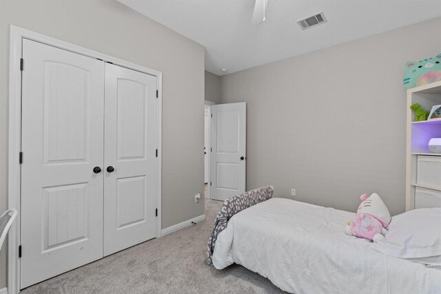 1017 Sussex Way, Round Rock, TX 78665 - bedroom featuring light carpet, a closet, baseboards, and a ceiling fan