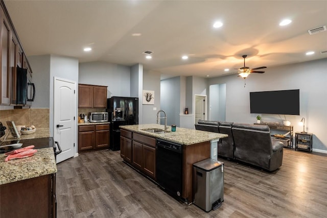 2612 American Dr, Lago Vista, TX 78645 - kitchen featuring black appliances, a sink, ceiling fan, dark wood finished floors, and decorative backsplash