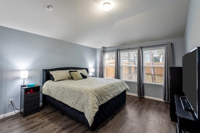 2612 American Dr, Lago Vista, TX 78645 - bedroom featuring vaulted ceiling, dark wood-style flooring, and baseboards