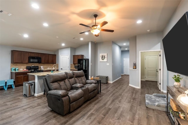 2612 American Dr, Lago Vista, TX 78645 - living room featuring dark wood-style floors, a ceiling fan, recessed lighting, and baseboards