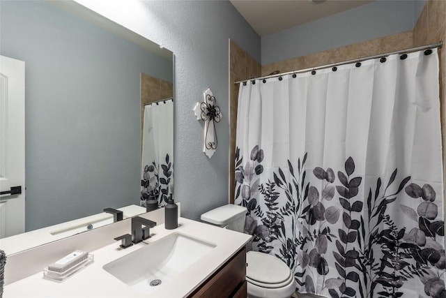 2612 American Dr, Lago Vista, TX 78645 - full bath featuring vanity, toilet, a textured wall, and curtained shower