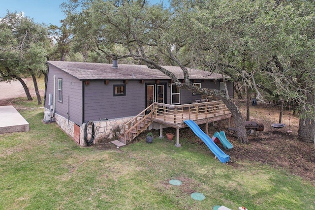 360 Little Barton Dr, Dripping Springs, TX 78620 - back of property with a lawn, a deck, roof with shingles, a playground, and stairway