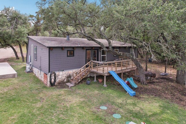 360 Little Barton Dr, Dripping Springs, TX 78620 - rear view of property with a lawn, a wooden deck, roof with shingles, a playground, and stairs