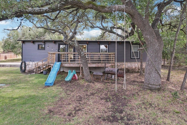 360 Little Barton Dr, Dripping Springs, TX 78620 - back of house featuring a deck, a lawn, and a playground