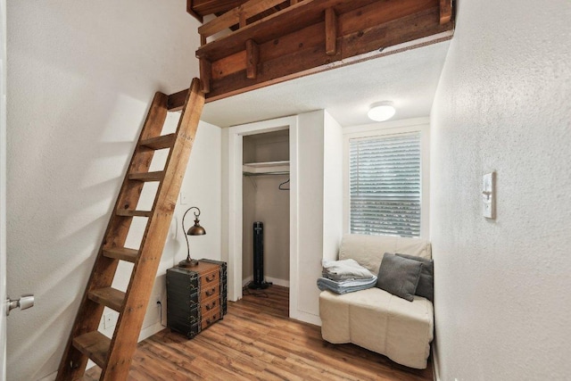 360 Little Barton Dr, Dripping Springs, TX 78620 - bedroom featuring wood finished floors, a closet, baseboards, and a textured wall
